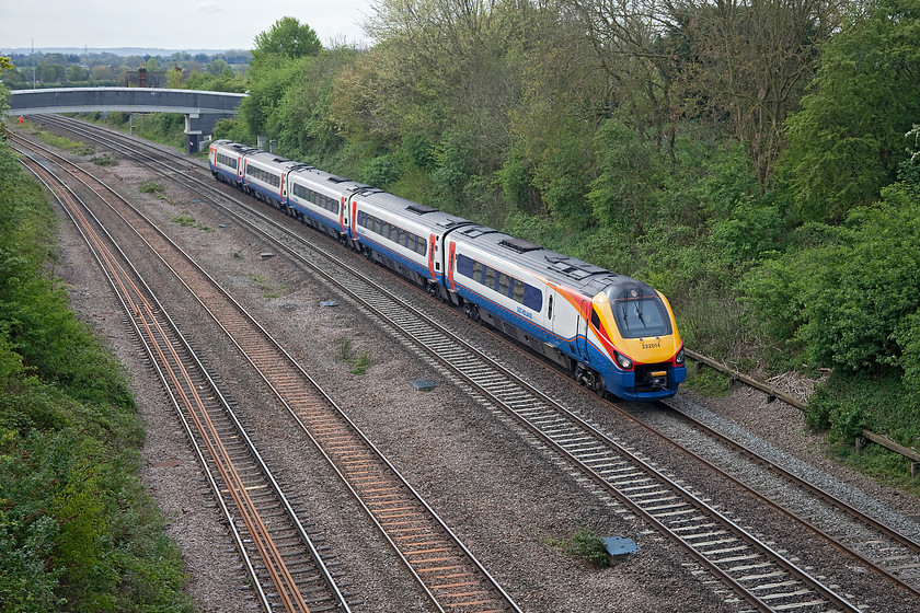 222014, EM 09.49 London St. Pancras-Crickelwood via Kettering ECS (5M17), Highfield Bridge, Oakley 
 Highfied Bridge in Oakley, Bedfordshire, offers a commanding view of the MML in both directions. In this view, looking south, 222014 works an unusual empty coaching stock move. The 09.49 St. Pancras to Cricklwood ECS should be a journey of about six miles. However, not if the train goes via kettering! For some reason unknown to me, this ECS move takes in an unnecessary one hundred and thirty mile diversion; can anybody shed any light on why this train makes this regular journey? 
 Keywords: 222014 ECS 5M17 Highfield Bridge Oakley