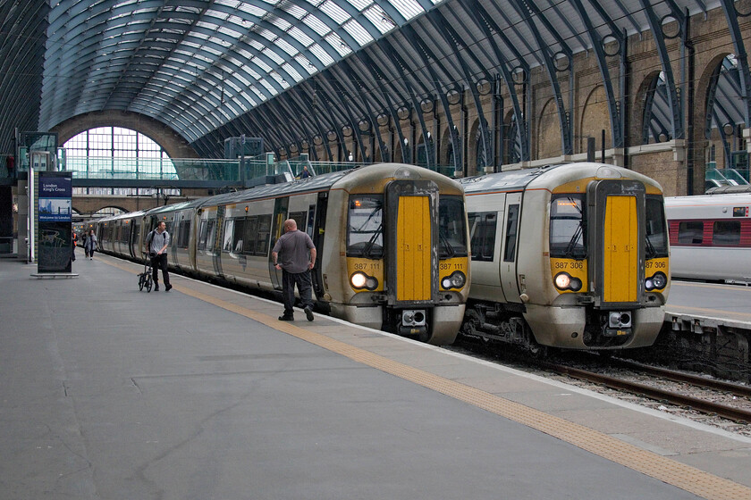 387111, GN 17.07 London King's Cross-Ely (1T48, 3L) & 387306, GN 17.12 London King's Cross-Peterborough (1P84, 9L), London King's Cross station 
 A pair of Great Northern services stand side by side at Kings Cross ready to leave within a few minutes of each other. To the left 387111 is about to close its doors and depart with the 1T48 17.07 service to Ely. Whilst to the right, 387306 will leave a few minutes later with the 1P84 train to Peterborough. 
 Keywords: 387111 17.07 London King's Cross-Ely 1T48 387306 17.12 London King's Cross-Peterborough 1P84 London King's Cross station Electrostar