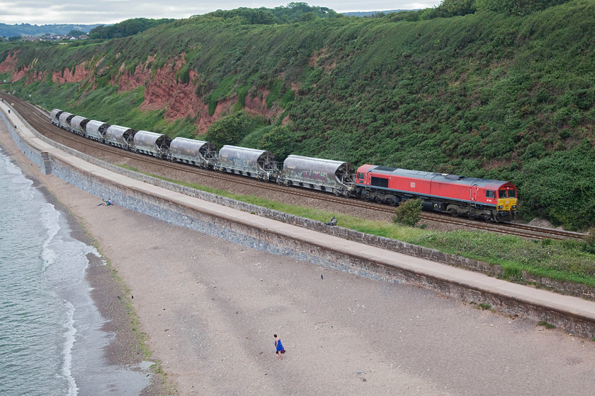 66185, 15.06 St. Blazey-Exeter Riverside (6C53), Langstone Rock 
 The regular 15.06 St. Blazey to Exeter Riverside china clay train passes Langstone Rock near Dawlish Warren. This is one portion of the train that joins together in Riverside Yard eventually making its way Cliffe Vale in Stoke. The reason for its split is the difficulties posed by such a heavy train over the Devon Banks. This namby-pamby approach would not have been taken in BR days, just put an extra locomotive on the front would have been their answer! 
 Keywords: 66185 15.06 St. Blazey-Exeter Riverside 6C53 Langstone Rock