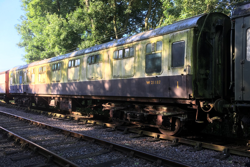 W21187, stored, Pitsford sidings 
 Former British Railways Mk1 Brake Composite Corridor (BCK) Coach W21187 was built in 1958 by Charles Roberts & Co. of Horbury Junction, Wakefield (also known as Chas Roberts & Co.) as part of Lot 30424. The lot was ordered in October 1956 with the final vehicle (Coach 21194) being delivered in January 1959. The coach spent its working career on the Western Region until withdrawal in 1982. It entered preservation moving around a number of heritage lines before arriving at the NLR in 2011. It is seen in Pitsford sidings awaiting restoration. As the NLR has no corridor stock in service, it would de be nice to see it in use on the line. 
 Keywords: W21187 Pitsford sidings