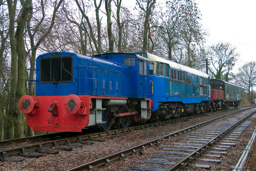 No. 764, stabled & 31289, undergoing restoration, Pitsford & Brampton sidings 
 Looking pretty miserable stabled in Pitsford and Brampton sidings to the north of the Pitsford station on the Northampton and Lamport Railway ara two locomotives, a restored wagon and a GUV. Leading the lineup is 0-4-0 Ruston & Hornsby 165DS class number 764. This is one of one hundred and twenty-four built with this one going to work for the Admiralty at RNAD Bedenham, Bridgemary, near Gosport. It worked at Bedneham shunting armaments around the site and was fitted with a (now removed) spark arrestor for obvious reasons! In 1975 it was sold and moved to Rail & Track Supplies at Wolverton who donated it to the fledgeling NLRbecoming its first locomotive in 1983. Tucked in behind 76 is resident 31289 undergoing some much-needed attention to ist incredibly rusty body. 
 Keywords: 764 31289 restoration Pitsford & Brampton sidings