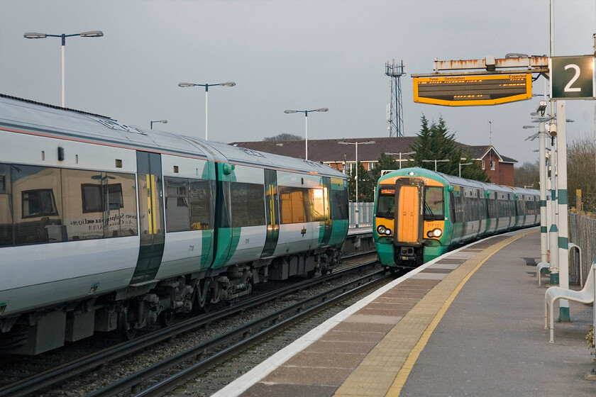 377116, unidentified up working & 377151, 17.34 London Victoria-Bognor Regis, Billingshurst station 
 A pair of Southern Electrostars pass as they both arrive at Billingshurst station. To the left 377116 is working an unidentified up working to Victoria whilst 377151 approaches with 17.34 London to Bognor Regis service. Notice that after a dull day the sun has come out for the last couple of hours raising the spirits! 
 Keywords: 377116 377151 17.34 London Victoria-Bognor Regis Billingshurst station Southern Electrostar