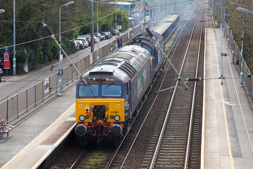 57301 & 37425, Norwich-Willesden LEs, Diss-Station 
 Having secured a shot of the 37 leading this combo through Diss station, it promptly stopped at a red signal. This gave me just enough time, before it cleared, to dash up on to the footbridge to snatch a going-away shot. 47201 'Scott Tracy' appears to be not under power and getting a tow from 37425 as part of a Norwich Crown Point to Willesden working, any more details gratefully received! 
 Keywords: 57301 37425 Norwich-Willesden LE Diss-Station