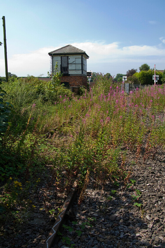 Trackbed and signal box looking SW towards Fosseway crossing SK100079 
 Looking approximately south-west from the trackbed of the former South Staffordshire Railway Company route between Lichfield and Walsall at Fosseway level crossing. Whilst passenger traffic ceased back in 1965 through freight continued to run for some years up until March 1983. The stub from Lichfield to the Charringtons oil storage facility at Brownhills was retained and saw two or three workings per week up until the closure oil the depot in 2003. With no further use for the line, it was closed in the spring of 2003. The rather nice 1875 LNWR signal box at Fosseway level crossing has survived and even showed some signs of basic maintenance at the time of my visit. 
 Keywords: Trackbed and signal box looking SW towards Fossway crossing SK100079 LNWR