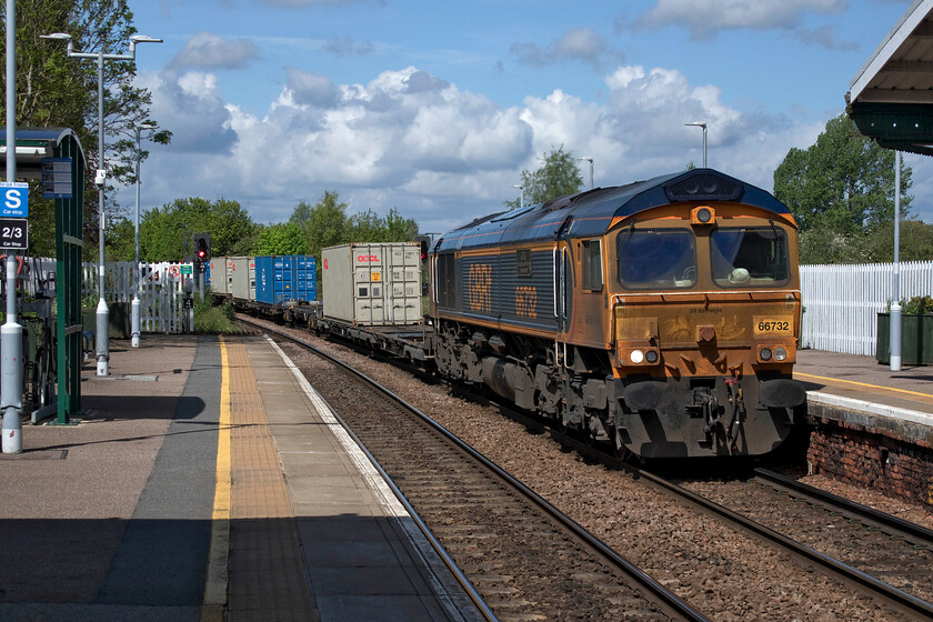 66732, 08.06 Doncaster iPort-Felixstowe South (4L28, 11L), March station 
 March remains a surprisingly busy location for freight given its somewhat isolated location on the network deep in the eastern counties. As to reinforce this, the third freight within half an hour passes through the station heading east with a very grubby 66732 'GBRf The First Decade 1999-2009 John Smith-MD' leading the 4l28 Doncaster iPort to Felixstowe South service. As I write this text on my iMacBook Air I cannot help but feel that naming a logistics centre as an iPort is a little incongruous trying to work out any connection to Mac products that appear to have ownership the i preffix? However, on investigation, I have discovered that the i in iPort stands for inland. Makes sense I suppose but I cannot help thinking that there's a touch of 'bandwagoning' going on with the name! 
 Keywords: 66732 GBRf The First Decade 1999 - 2009 John Smith - MD 08.06 Doncaster iPort-Felixstowe South 4L28 March station Freightliner