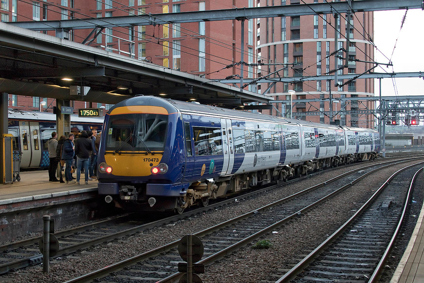 170473, NT 17.57 Leeds-Doncaster (2B27, RT), Leeds station 
 The last time that I saw this class 170 was at Edinburgh Waverley station. Since then, it has moved south and is now operated by Northern and looks very different in its new livery. 170473 is boarding at platform 10A ready to work the 17.57 to Doncaster. I'll leave you to decide if this is the best use of resources, to operate a diesel unit under the wires to Doncaster. 
 Keywords: 170473 17.57 Leeds-Doncaster 2B27 Leeds station