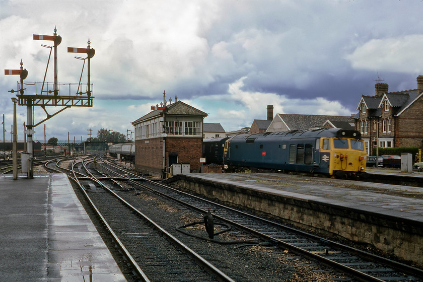 50031, 10.05 Paignton-London Paddington, Taunton station 
 The menacing clouds in the previous photograph have done their worst and deposited some torrential rain over a relatively brief period. 50031 'Hood' takes the up through road through Taunton station leading the 10.05 Paignton to Paddington service. Unfortunately, the train was going a little too fast for the maximum shutter speed that I could muster on the camera so there is a little motion blur. Notice the GUV tucked in just behind the locomotive that was common practice on summer express services from the West Country. 
 Keywords: 50031 10.05 Paignton-London Paddington Taunton station Hood