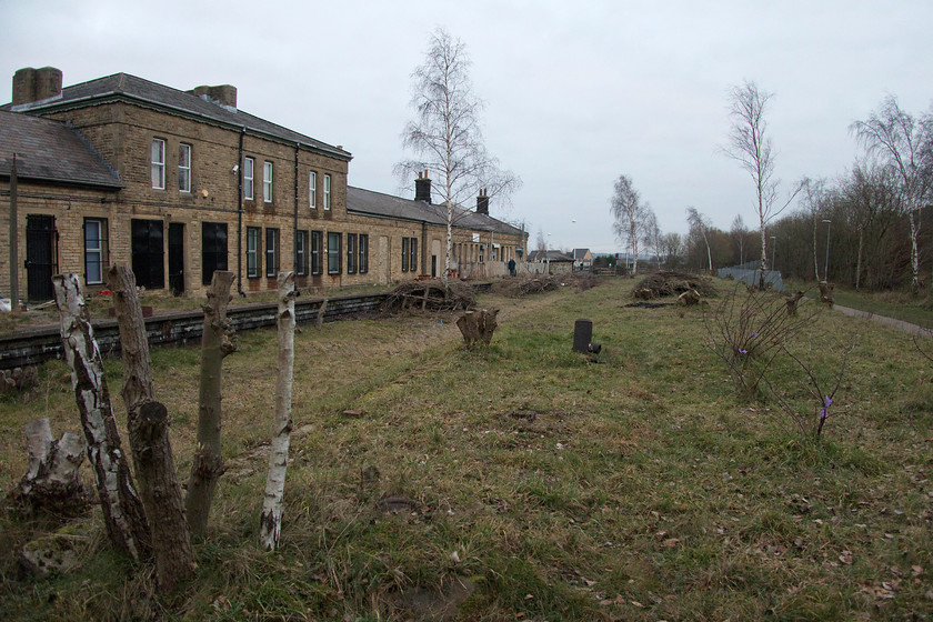 Former Woodhead platforms, Penistone station 
 The former Woodhead route station building at Penistone. The grand station buildings had extensive canopies along the entire frontage and there were also a number of station structures on the island platform directly in front of the camera. Whilst nature has taken over the platforms and trackbed, recent clearance of the trees has re-opened the site somewhat. 
 Keywords: Penistone station