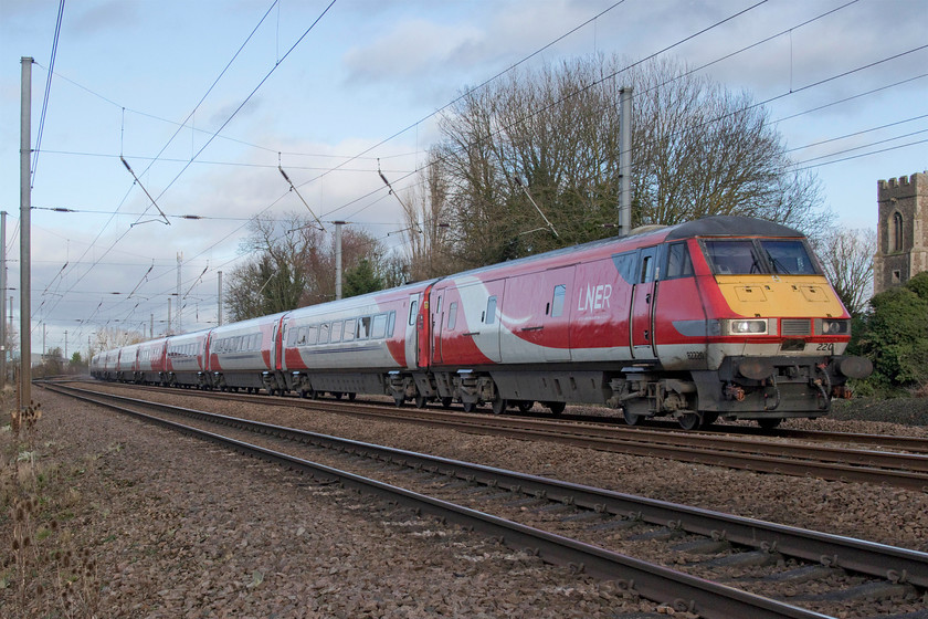 82220 & 91101, GR 09.30 Edinburgh Waverley-London King`s Cross (1E09, 2L), Gill`s Crossing 
 82220 passes Gill's crossing in the village of Offord Cluny leading the 09.30 Edinburgh to King's Cross. 91101 'Flying Scotsman' is doing the all the work at the rear of the train. Offord Cluny's Church of All Saints fifteenth century tower can just be seen to the far right of the image. 
 Keywords: 82220 91101 09.30 Edinburgh Waverley-London King`s Cross 1E09 Gill`s Crossing LNER Flying Scotsman