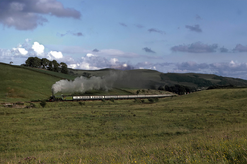 4472, return leg of The North Yorkshireman, Skipton-Carnforth, Giggleswick SD793638 
 In lovely evening light at Giggleswick in North Yorkshire, 4472 'Flying Scotsman' heads up the 1:100 rising gradient with the returning North Yorkshireman railtour from Skipton to Carnforth. Whilst this photograph can be replicated today, the scene is somewhat blighted by the A65 Settle relief road that is parallel to the railway on the far side. There is also considerable tree growth along the side of the new road that spoils the views of the Yorkshire fields and dry stone walls. 
 Keywords: 4472 The North Yorkshireman Skipton-Carnforth Giggleswick SD793638