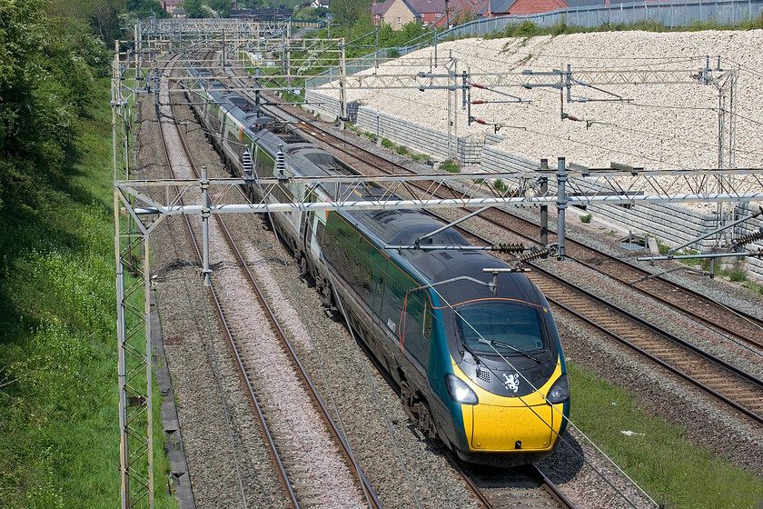 390044, VT 11.15 Wolverhampton-London Euston (1B38, 2E), Ashton Road bridge 
 Instantly recognisable as the record attempting 390044 by its lionheart crest on the front it is seen passing between Roade and Ashton working AWC's 11.15 Wolverhampton to Euston service. Named 'Royal Scot' prior to the record attempt on 17.06.21 I suspect that another attempt will be made to beat the APT's time set in 1984. 
 Keywords: 390044 11.15 Wolverhampton-London Euston 1B38 Ashton Road bridge AWC Avanti West Coast Pendolino