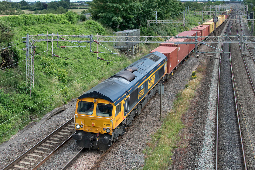 66708, 12.05 London Gateway-Hams Hall (4M46, 3L), Victoria bridge 
 With a toot on the horn from the driver, 66708 'Jayne' leads the 12.05 London Gateway to Hams Hall 4M46 Freightliner past Victoria bridge just south of Roade. This particular working was reassuringly well loaded compared to the many freight trains that were running about half loaded. 
 Keywords: 66708 12.05 London Gateway-Hams Hall 4M46 Victoria bridge Jayne GBRf