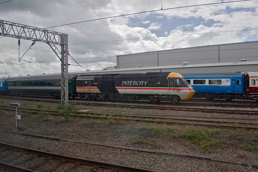 43049 & M41182, stabled, LSL Crewe 
 Looking superb in its reproduction InterCity Swallow livery 43049 'Neville Hill' stands at Crewe's LSL depot. This HST power car and a set of stock is proving to be a distinct hit with enthusiasts and charter operators alike. The sets are frequently out to all four corners of the country carrying paying passengers enjoying the comfort and luxury of Mk. III coach travel as a distinct contrast to the seating installed on new stock! 
 Keywords: 43049 M41182 stabled LSL Crewe Intercity Neville Hill