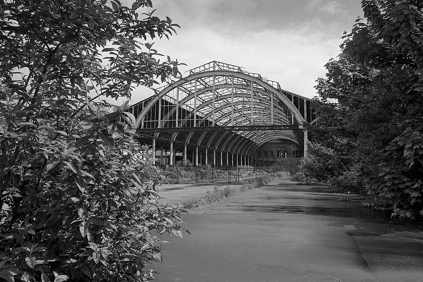 Trainshed from platform 1, Bath Green Park station 
 Another view of the main trainshed taken from country end of the former platform one. Bhudlia and other greenery are slowly taking over and returning the site to nature. This view was taken just fifteen years after the station closed. 
 Keywords: Trainshed from platform 1 Bath Green Park station