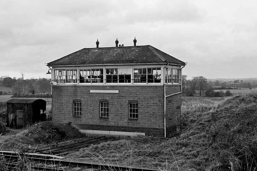 Bradford Junction signal box (GW, 1933) 
 The signal box at Bradorfd Junction was not photographed very often as it was somewhat remote being located away from the primary route in use at this time. The Avon Valley line between Trowbridge and Bradford-on-Avon can be seen curving away behind the box. In the foreground is the former mainline route via Melksham to Thingley Junction near Chippenham. The box is mid-sized Type 7 design dating from 1933. It lingered on in use until 1990 with rationalisation taking place all around it with the removal of the north chord and the singling of the Melksham route throughout. Today, with passenger services introduced again and frequent use by freight trains I suspect that many rue the day that the earlier rationalisation took place! 
 Keywords: Bradford Junction signal box