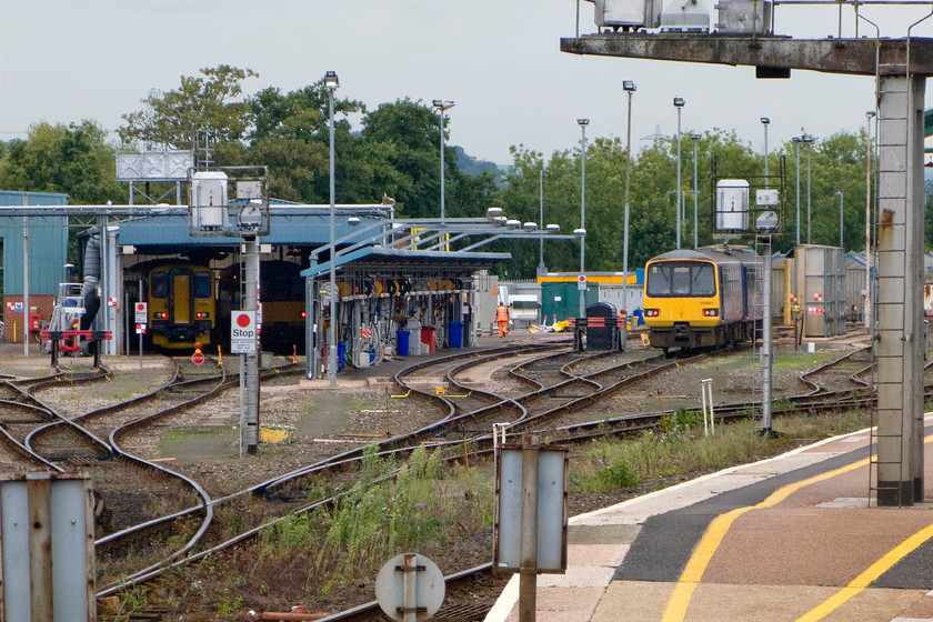 Class 153, Class 142 & 142621, stabled, Exeter St. David`s depot 
 There has been a diesel facility adjacent to Exeter St. David's station for many years. It undertakes maintenance, some exams as well as fueling and cleaning. In this view from our train, as we depart from the station, three units are seen the only one identifiable is 142621 to the far right. In the coming years, this facility is set to expand massively with the arrival into service of the new bi-mode units that will also be maintained here. 
 Keywords: Class 153 Class 142 142621 Exeter St. David`s depot