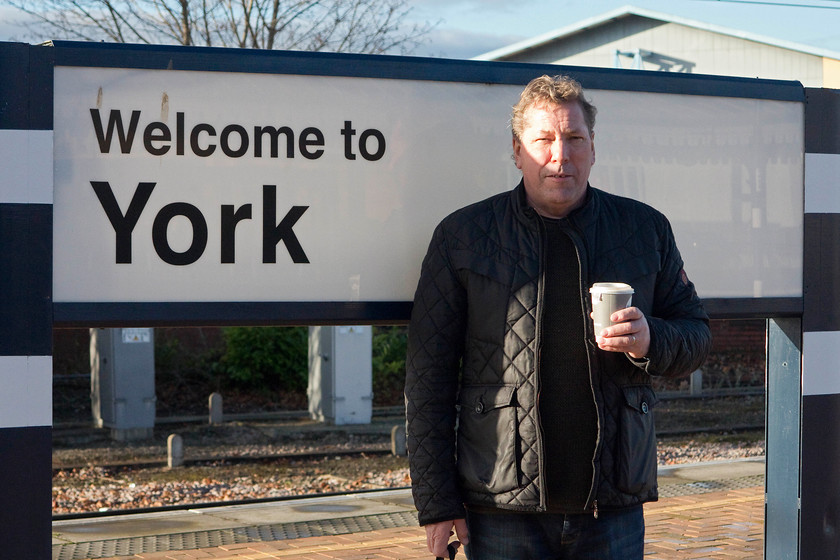 Trevor, York station 
 My working partner and boss, Trevor stands at, 'urhhhh, ummm', York! Notice that the signs are still painted in the famous and recognisable blue of the much lamented GNER operator. 
 Keywords: Trevor York station