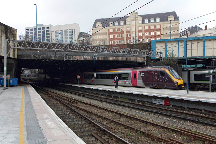 221136, XC 11.00 Bristol Temple Meads-Manchester Piccadilly (1M37, RT), Birmingham New Street station 
 Security personal patrol larger stations (and many smaller ones) as can be seen in this picture at Birmingham New Street. Even though this particular security operative did not bother me, on another occasion whilst waiting for a train I photographed a 350 and was told 'you can't take pictures on this station (Birmingham)'. I pointed out a person nearby who had her mobile out and was taking a picture of her friends; I was told 'that's different'! I did not get an explantation as to how that was the case! 221136 arrives working the 11.00 Bristol Temple Meads to Manchester Piccadilly the 1M37. 
 Keywords: 221136 1M37 Birmingham New Street station