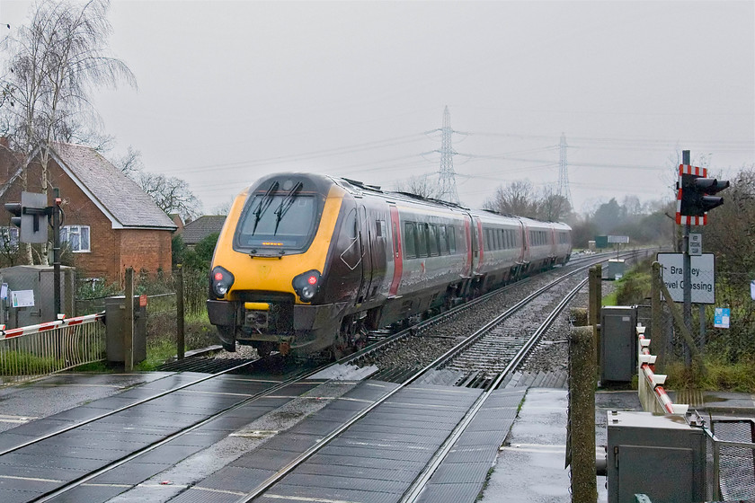 Class 220, XC 13.46 Southampton-Edinburgh (1S52), Bramley station 
 In torrential rain and appalling lighting I thought it appropriate to take a going-away photograph of voyager - can somebody please email me and advise why I did this! So for the record, an unidentified Class 220 heads over Bramley level crossing from the platform end with the 13.36 Southampton to Edinburgh Waverley. 
 Keywords: Class 220 XC 13.46 Southampton-Edinburgh 1S52 Bramley station CrossCountry Voyager