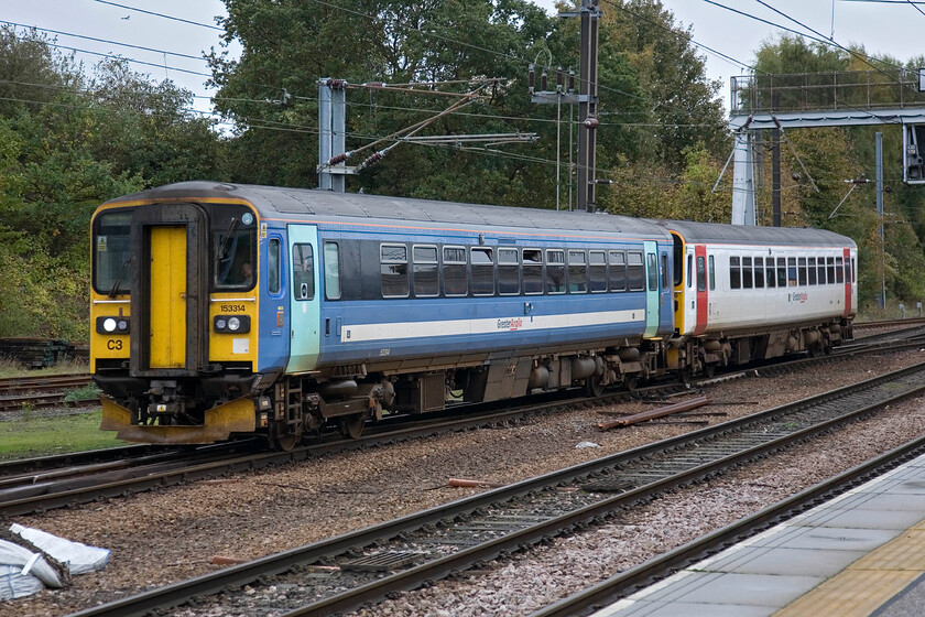 153314 & 153306, LE 10.17 Great Yarmouth-Norwich, Norwich station 
 The old and new look of Greater Anglia as seen on a pair of Class 153 units as they arrive at Norwich. Leading the 10.17 terminating service from Great Yarmouth is 153314 wearing the old National Express paint scheme with 153306 having been treated to the much brighter 'new look' livery.

PS from December 2013 the 'new look' as I describe above was to be branded as Abellio Greater Anglia (note added 02.25) 
 Keywords: 153314 153306 10.17 Great Yarmouth-Norwich Norwich station