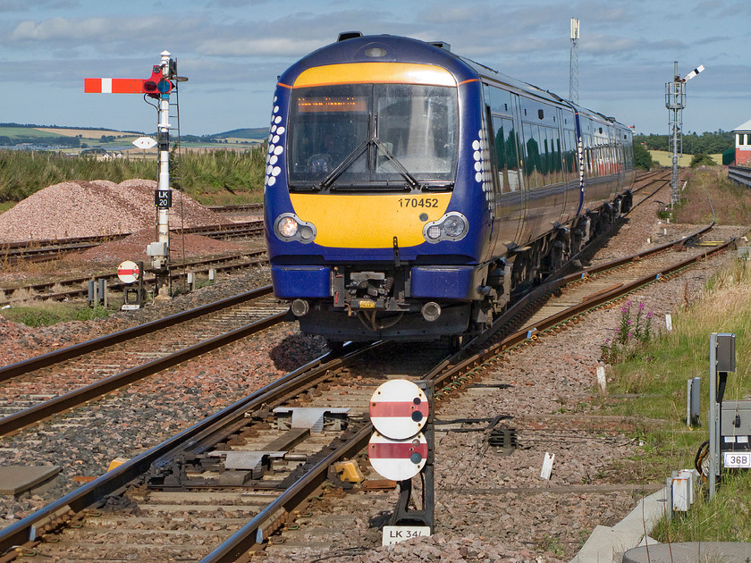 170452, SR 14.39 Aberdeen-Glasgow Queen Street (1T32), Laurencekirk station 
 There are no fewer than seven mechanical signals in this photograph taken from the platform end at Laurencekirk station. 170452 is running at speed working the 1T32 14.39 Aberdeen to Glasgow Queen Street that will not stop at the station. Laurencekirk station was shut in 1967 only to be rebuilt and opened again in May 2009 with passenger numbers far in excess of those projected. Funding came largely from the forward-thinking Scottish parliament. Whilst I am a strong unionist I have to hand it to the devolved administration acknowledging that their pro-rail stance is breath of fresh air and something we in England and Wales should learn from. 
 Keywords: 170452 14.39 Aberdeen-Glasgow Queen Street 1T32 Laurencekirk station ScotRail