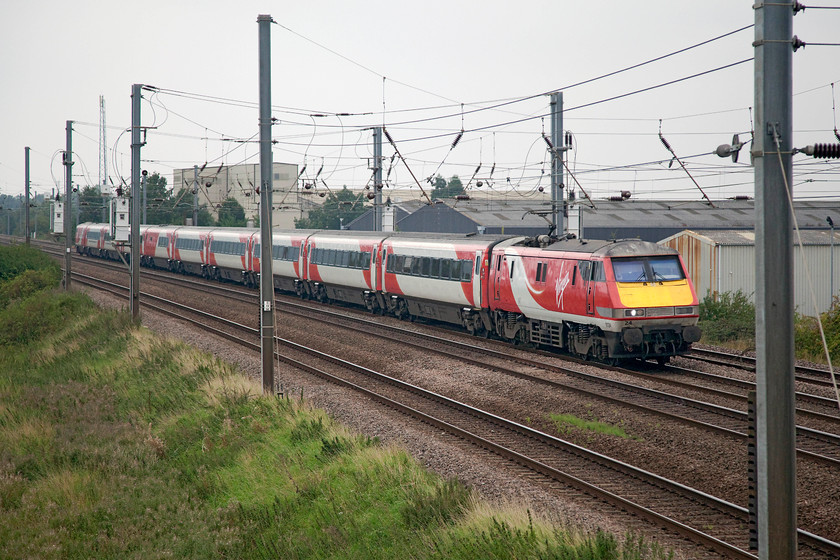 91124, GR 10.30 London Kings Cross-Edinburgh Waverley (1S12, 1L), Sandy TL176510 
 91124 leads the 10.30 King's Cross to Edinburgh Waverley 1S12 express past New Zealand footbridge just north of Sandy in Bedfordshire. With the exception of a Mk. III HST I could think of no better way to travel to Edinburgh than in a Mk. IV. I wonder if the new IETs will be as comfortable and as durable as these excellent trainsets have been over the twenty years that have been operating on the ECML? 
 Keywords: 91124 1S12 Sandy TL176510