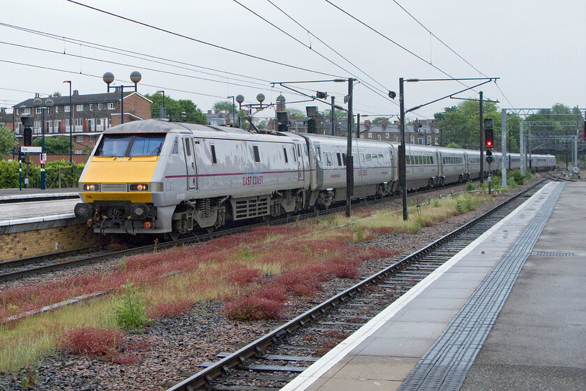 91108, GR 14.30 London King's Cross-Newcastle (1N21), York station 
 The 14.30 King's Cross to Newcastle express arrives at a now wet York station. For the last week in May, it was particularly cold and wet for the duration of our stay in York! 
 Keywords: 91108 14.30 London King's Cross-Newcastle 1N21 York station East Coast InterCity 225