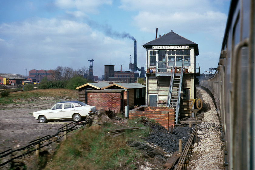 Wath Road Junction signal box (Mid, date not known) 
 A scene that is the epitome of Yorkshire in times past! To the centre-left is the winding tower of Manvers Colliery with its coking plant belching out the black smoke to the centre. Our train has just left the Swinton and Knottingley Joint Railway (S&K) route that is the only one still in use today and is diverging onto the now-closed and long removed Midland route with Wath Road Junction signal box dominating the view. The signalman's white Morris Marina, complete with a rather natty vinyl roof, is parked on an area of land now occupied by a large RBS office as part of the Adwick Business Park. It is absolutely astonishing to compare just this very ordinary photograph with the present-day view with all that can be seen here comprehensively wiped away. 
 Keywords: Wath Road Junction signal box Midland Railway Morris Marina