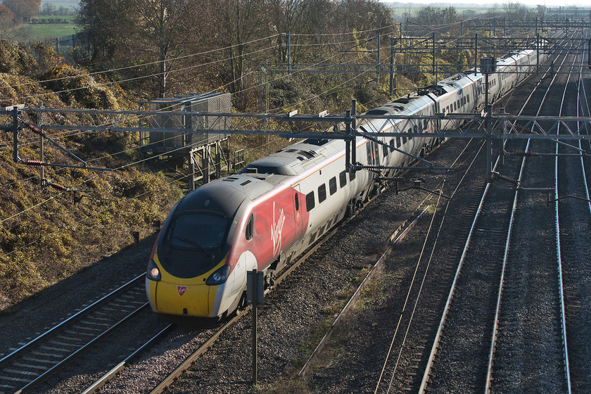 390039, VT 10.50 London Euston-Wolverhampton (9G06, RT), Victoria bridge 
 390039 passes Victoria bridge just north of Hanslope Junction on the down slow line forming the 9G06 10.50 Euston to Wolverhampton. This was one of the last trains to take this diversionary route via Northampton as the Weedon Loop was about to be passed back after engineering works. In fact, the following down train that went via the normal Weedon route reached Rugby in front of this 9G06! 
 Keywords: 390039 10.50 London Euston-Wolverhampton 9G06 Victoria bridge