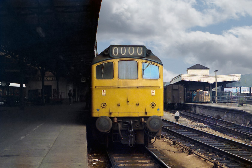 Class 25, unidentified working, Bristol temple Meads station 
 Whist class 25s did chunter about on the Western Region, they were not frequent visitors to the Bristol area. Again, no number is recorded for this one but I seem to remember that it was on a parcels working of some kind. Note the loaded BRUTE trolleys on the adjacent platform and the end of an ex. Southern Parcels van. These two platforms were permanently shut to passenger trains at this time. Today, I suspect Temple Meads would be crippled if, what are now platforms thirteen and fifteen, were out of use!