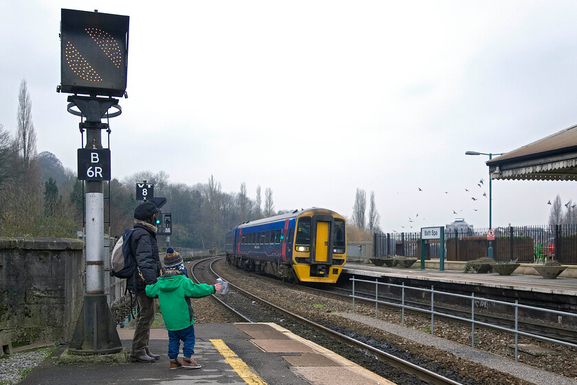 158955, GW 12.37 Cardiff Central-Portsmouth Harbour, Bath Spa station 
 What is it about young children waving at trains? Another admirer and his mum greet the arrival of the 12.37 Cardiff to Portsmouth First Great Western service at Bath Spa worked by 158955. Back in 1976 on a trainspotting trip to Bath, I photographed in the other direction crouching down on the platform ramp, something today that would incur the wrath of station staff, see..... https://www.ontheupfast.com/p/21936chg/24037709204/b578-weymouth-bristol-temple-meads 
 Keywords: 158955 12.37 Cardiff Central-Portsmouth Harbour Bath Spa station FGW