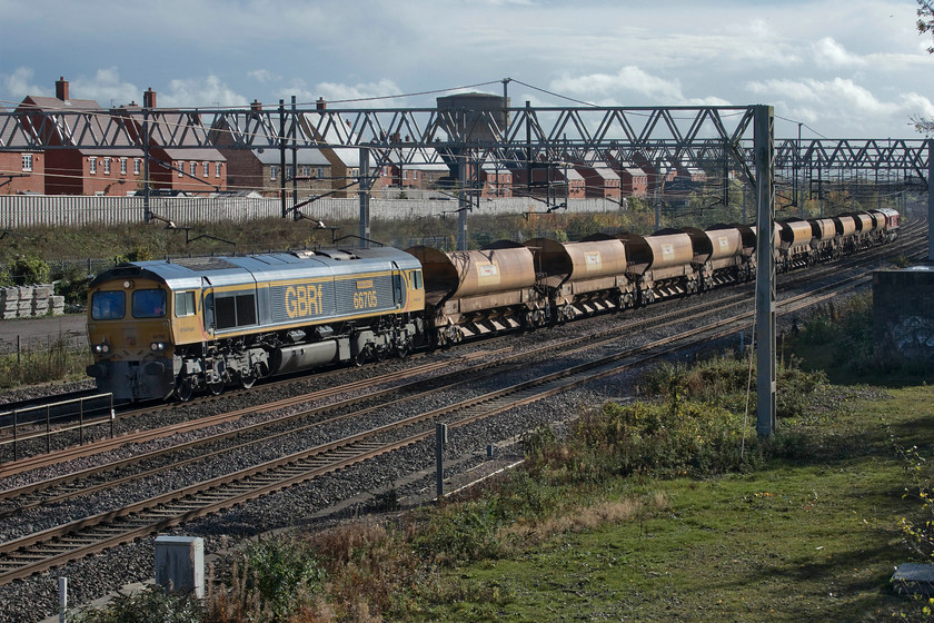 66705 & 66055, 11.00 Denbigh Hall South-Bescot Engineers (6G54, 3E), site of Roade station 
 With the sun putting in a welcome appearance after a largely cloudy morning, 66705 'Golden Jubilee' passes Roade leading the 11.00 Denbigh Hall (Bletchley) to Bescot engineering train. The rake of HQA ballast wagons had been involved in engineering works in the Milton Keynes area the previous night. Bringing up the rear of the train is 66055 'Alain Thauvette'. 
 Keywords: 66705 66055 11.00 Denbigh Hall South-Bescot Engineers 6G54 site of Roade station Golden Jubilee HQA autoballaster Alain Thauvette