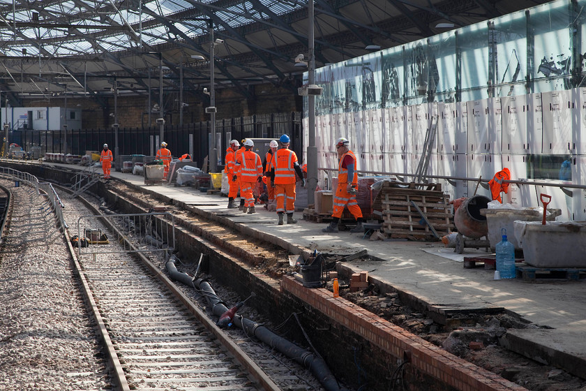 Re-building work, platform 10, Liverpool Lime Street station 
 Part of the ever-present 'orange army' involved in the rebuilding of platform 10 of Liverpool Lime Street. Just an observation.....has anybody ever studied track gangs in action? More of them seem to be on their mobile 'phones discussing something or other of great importance no doubt rather than actually doing something! Next time that you are in a position to watch a group.....look to see if you can see what I am talking about! I can note two people in this image on their 'phones. 
 Keywords: Re-building work, platform 10, Liverpool Lime Street station