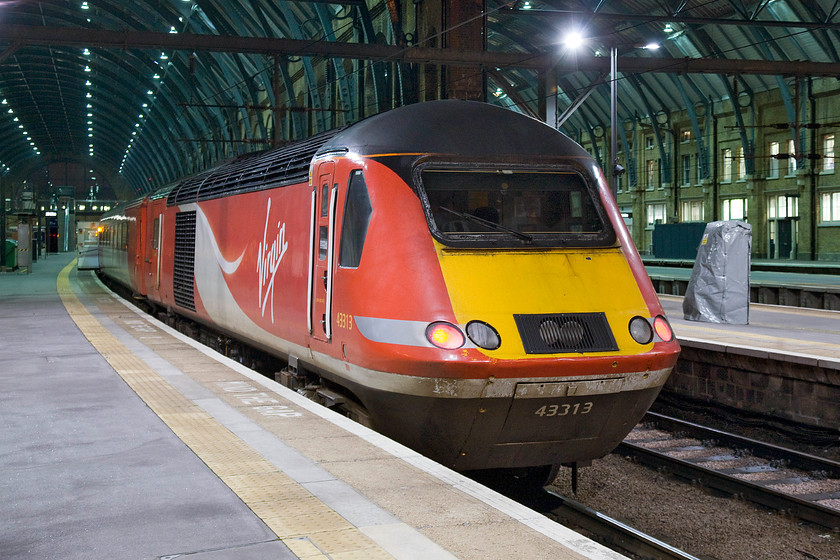 43313, GR 22.13 London King's Cross-Bounds Green TMD ECS (5Y19), London King's Cross station 
 43313 waits at King's Cross having arrived from the north. As it's late on a Saturday evening rather than head straight back again with another VTEC service train will run as empty coaching stock for servicing at Bounds Green. Running as 5Y19 it will leave in about fifteen minutes. As 43113 this power car has always been in operation on the east coast being introduced as part of set 254029 in March 1979. 
 Keywords: 43313 22.13 London King's Cross-Bounds Green TMD ECS 5Y19 London King's Cross station HST Empty Coaching stock VTEC Virgin Trains East Coast