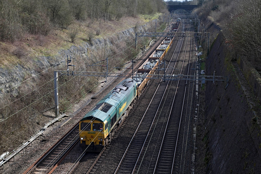 66551 & 66531, 09.36 Camden South Junction-Crewe Basford Hall (6Y58), Roade Cutting 
 66551 leads the 09.36 Camden South Junction to Crewe Basford Hall engineer's train through Roade Cutting. Just visible on the back of the train is 66531. These trains do not run every Sunday but they are fairly regular, a quick check of Realtime trains during the morning reveals if it's running or not. 
 Keywords: 66551 66531 09.36 Camden South Junction Crewe Basford Hall 6Y58 Roade Cutting