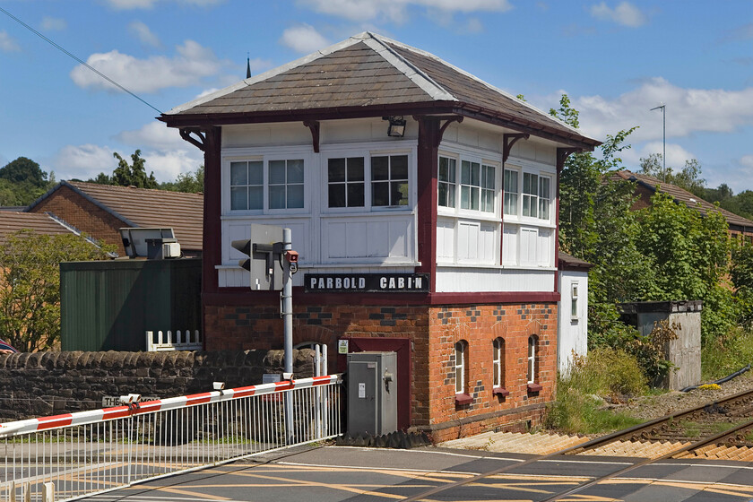 Parbold Cabin signal box (S & F, 1877) 
 I have a number of images of Parbold Cabin signal box but I make no excuses for including another in some welcome afternoon sunshine. The superb Lancashire and Yorkshire box has been a feature on the village's Station Road since it opened in 1877. The box is Grade II listed so its future is secure. The signalman is kept busy as a regular service operates along the line to and from Wigan and the crossing is busy with local traffic. 
 Keywords: Parbold Cabin signal box S & F 1877 L & Y