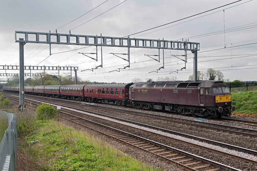 47746, outward leg of The Cumbrian Mountain Express, London Euston-Carlisle (1Z86), Ashton Road Bridge 
 Realtime Trains indicated that the 1Z86 Cumbrian Mountain Express was heavily delayed so I headed back home from Victoria Bridge. By the time I had got home and had breakfast it was on its way! After finishing my tea and toast I walked across the field from home to witness 47746 'Chris Fudge 29.7.70-22.6.10' leading the late running railtour as it approached Roade on the WCML. The usual haulage, in the form of 86259, had failed at Euston and the 47 had to be rapidly summoned to haul the special north. 
 Keywords: 47746 The Cumbrian Mountain Express London Euston-Carlisle 1Z86 Ashton Road Bridge