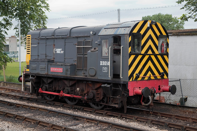 D3014, stabled, Paignton station 
 One of the South Devon Railway's class 08 shunters, D3014 'Samson' sits in the siding adjacent to Paignton station. This particular example is a very early one built at Derby in 1952 entering service as 13014. It never actually received a TOPS number as it was withdrawn in 1973 whence it moved for further work at the NCB Merthyr Vale colliery in South Wales. 
 Keywords: D3014 Paignton station