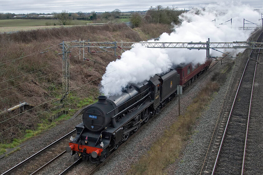 44871, 08.59 Southall WCR-Castleton Hopwood GF (5Z43, 5E), Victoria bridge 
 Former LMS Black 5 44871 is seen returning home for a New Year rest just south of Roade. Running as 5Z43, the 08.59 Southall West Coast to Castleton Hopwood (for access to East Lancashire Railway) the train ran to time for its entire journey complete with a tiny Father Christmas attached to the centre lamp. The Black 5 has seen intense use over recent months operating various charters and specials so I suspect it will be receiving a good service during the quiet period in the New Year. 
 Keywords: 44871 08.59 Southall WCR-Castleton Hopwood GF 5Z43 Victoria bridge LMS Stanier Class 5MT