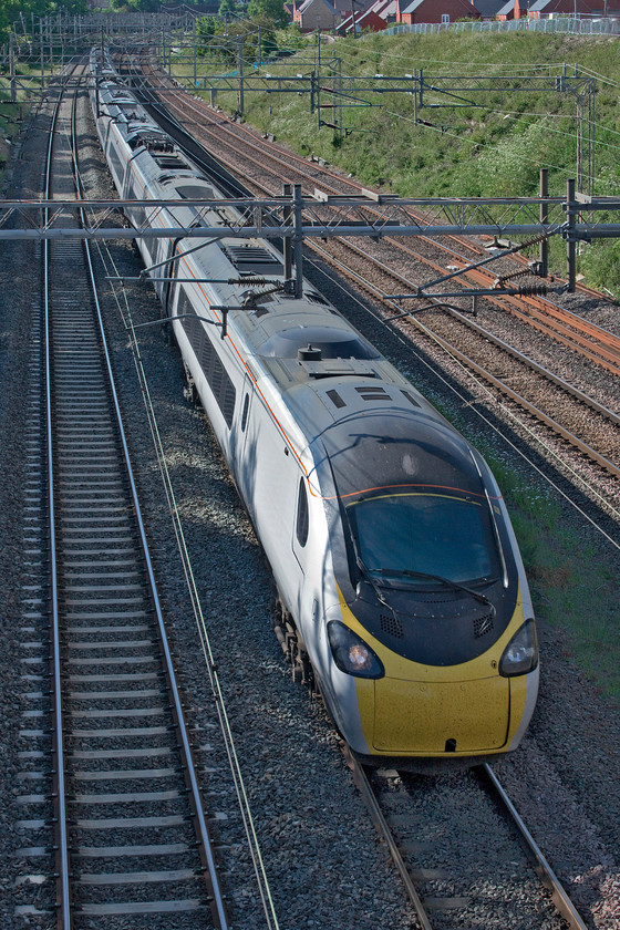 390148, VT 16.30 Birmingham New Street-London Euston (1B53, 1E), Ashton Road bridge 
 390148 'Flying Scouseman' is about to whip underneath Ashton Road bridge just south of Roade. It is working the 1B53 16.30 Birmingham New Street to Euston service. 
 Keywords: 390148 16.30 Birmingham New Street-London Euston 1B53 Ashton Road bridge Avanti West Coast Pendolino Flying Scouseman