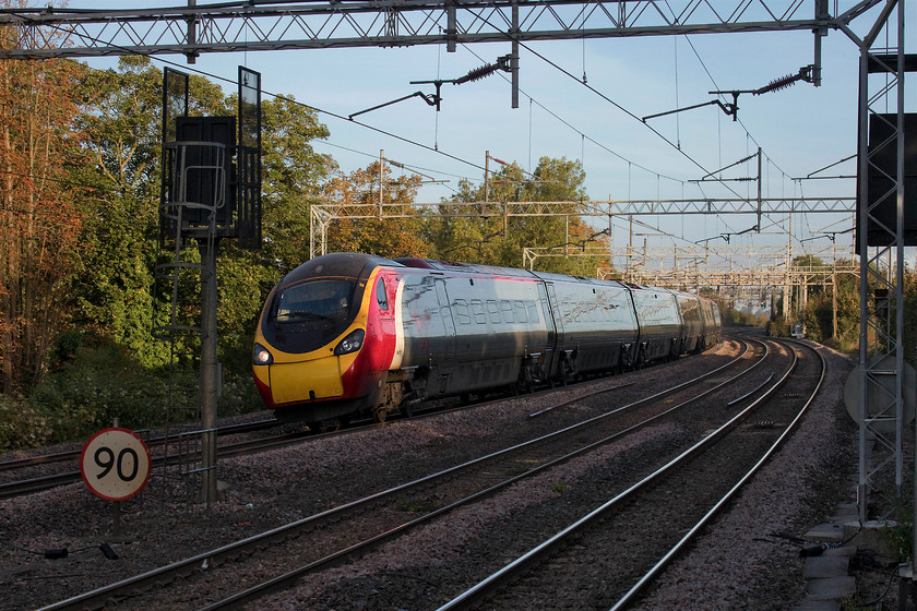 390137, VT 06.10 Manchester Piccadilly-London Euston (1A05, 3L), Wolverton station 
 390137 'Virgin Difference' just dips into the early morning shadows at Wolverton as it heads south on the up fast with the 06.10 Manchester Piccadilly to Euston. I love the colours and the lighting of autumn but it can create issues with extreme contrast as shown here but some tweaking with Photoshop usually results in a reasonable image. 
 Keywords: 390137 1A05 Wolverton station