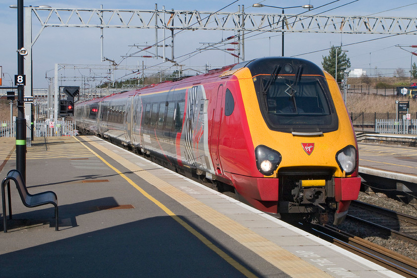 221115, VT 08.55 Holyhead-London Euston (1A25), Milton Keynes Central station 
 The uniquely branded 221115 'Polmadie Depot' slows for its stop at Milton Keynes forming the 08.55 Holyhead to Euston. The Voyager wears a co-branded livery to celebrate the partnership between Bombardier and Virgin Trains. 
 Keywords: 221115 08.55 Holyhead-London Euston 1A25 Milton Keynes Central station