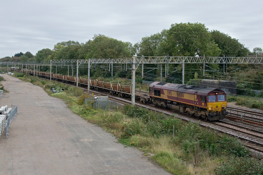 66004 & 66158, 12.00 Euston-Bescot (6R05, 28L), site of Roade station 
 Passing the site of Roade's closed station and sidings is the 6R05 Euston to Bescot engineering train. It is carrying used track panels removed from the Euston station area resulting from HS2 works. Unfortunately, on this occasion, there was a problem and the works over ran and caused hours of delays in and out of Euston for the whole of Sunday. Leading this train is 66004 with 66158 bringing up the rear. 
 Keywords: 66004 66158, 12.00 Euston-Bescot 6R05 site of Roade station