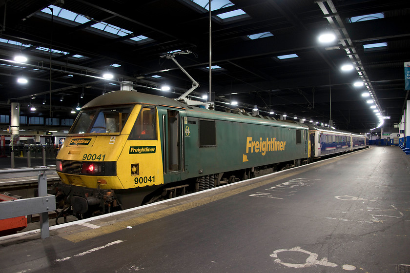 90041, CS 19.34 Wembley Inter City Depot-London Euston (5S95), London Euston station 
 Having made the short journey from Wembley Yard as the 5S95 ECS, 90041 is detached from the Caledonian Sleeper stock in readiness for its departure in a couple of hours. At the time of writing, this stock, introduced in the mid 1980s, is on borrowed time . The new Mk.IV sleeper stock (built abroad) is under testing ready for introduction by the end of 2018. In 1984. I remember chasing Mk.I sleeper stock all over the country, who would have thought some 35 years later I would be photographing their replacements prior to withdrawal? 
 Keywords: 90041 CS 19.34 Wembley Inter City Depot-London Euston ECS 5S95 London Euston station