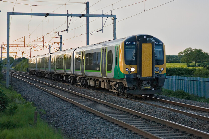 350111, LM 18.54 Birmingham New Street-London Euston, Milton Malsor 
 The evening's 18.54 Birmingham New Street to Euston captures some welcome late soft sun as it passes Milton Malsor. As can be seen, palisade fencing has recently been installed at this spot so my image of 350111 has been taken now using some steps to gain some height. 
 Keywords: 350111 18.54 Birmingham New Street-London Euston Milton Malsor London Midland Desiro