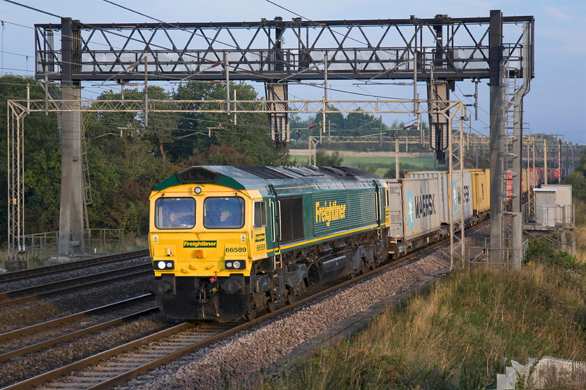 66589, 04.10 Crewe Basford Hall-Felixstowe North (4L89), Roade Hill 
 Looking as if it has been in receipt of a recent coat of paint 66589 leads the 4L89 04.10 Crewe Basford Hall to Felixstowe Freightliner. It is seen on the southern WCML approaching the village of Ashton between Milton Keynes and Northampton. 
 Keywords: 66589 04.10 Crewe Basford Hall-Felixstowe North 4L89 Roade Hill Freightliner