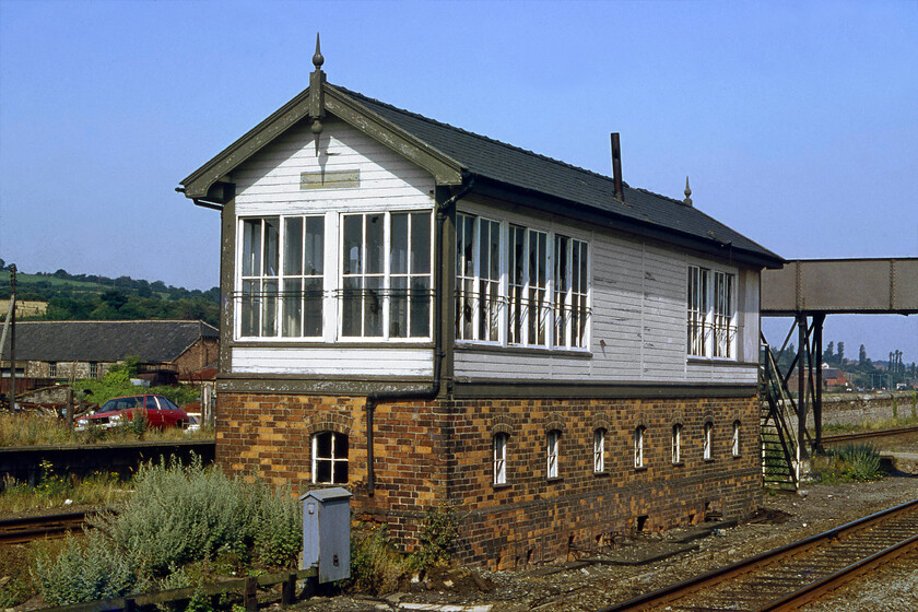 Bagillt signal box (LNW, 1907) 
 Bagillt signal box was a remarkable survivor even when photographed here in 1981! It had already been closed for nine years and was suprisingly intact except for some broken windows. The box was a Type 5 London and North Western structure located, as was common practice on this route, in the centre of the four tracks at the site of the station that had closed in February 1966. I am not sure how long the box lingered on but it did seem a casualty waiting to happen thanks to local arsonists! Notice the former station footbridge beyond the box, this is still in use today permitting access to the Wales Coast long-distance footpath. 
 Keywords: Bagillt signal box L&NWR 1907