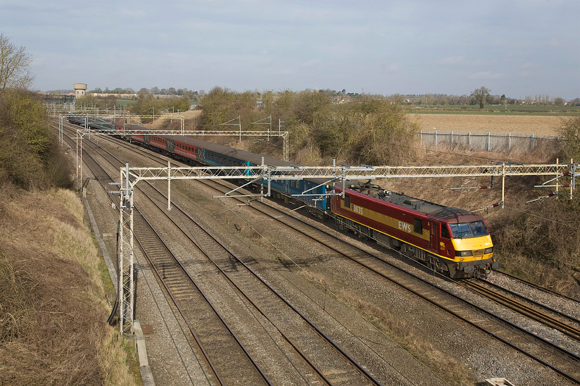 90035, outward leg of The Flame Train, Newcastle-Wembley-Central-(0001Z0090),-Victoria-bridge 
 This special train left Newcastle Central at an unearthly hour and is seen here passing Victoria bridge on the Southern WCML on the final part of its journey to Wembley Central. It is being led by 90035 that will have taken over the train somewhere en-route. The mixed bag of Mk. II stock is carrying a whole load of young Christians to the CYMFed Flame Congress at Wembley. 
 Keywords: 90035 The Flame Train, Newcastle-Wembley Central 1Z90 Victoria bridge