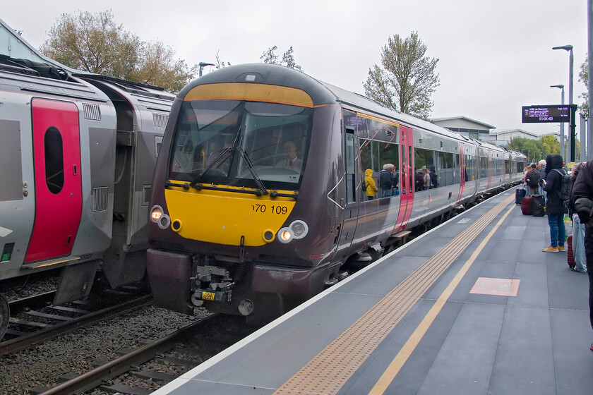 170109, XC 09.07 Nottingham-Cardiff Central (1V06, 8L) & 220021, XC 10.00 Bristol Temple Meads-Manchester Piccadilly (1M33, 12L), Worcestershire Parkway station 
 170109 comes to a halt at Worcestershire Parkway station working CrossCountry's 09.07 Nottingham to Cardiff train. To the left 220021 is waiting to depart working the 10.00 Bristol to Manchester train. Andy and I found the new Worcestershire Parkway station rather barren and open with limited facilities apart from a mobile coffee van near the entrance. However, the station appeared to be patronised as seen in this image In fact, the Class 170 was full and standing when it departed proving how inadequate a three-car DMU is for an inter-regional service such as this. 
 Keywords: 170109 09.07 Nottingham-Cardiff Central 1V06 220021 10.00 Bristol Temple Meads-Manchester Piccadilly 1M33 Worcestershire Parkway station CrossCountry Voyager Turbo