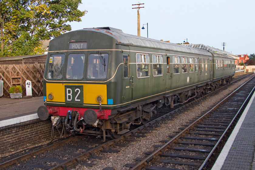 M51192 & M56352, 15.45 Sheringham-Holt, Sheringham station 
 Rather than walk back to Kelling to collect the car I decided on this occasion to take the train as the 15.45 to Holt was about to leave Sheringham station as I was passing! Here the train formed by former Class 101 DMU cars M51192 and M56352 waits to leave Sheringham that I am going to board. Notice the concrete milepost on the platform showing forty-two and three-quarter miles from the now-closed Norwich City station following the former M&GN route via Holt and Melton Constable. 
 Keywords: M51192 M56352 15.45 Sheringham-Holt Sheringham station Class 101 DMU